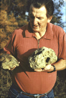 Rex Gilroy Holding Two Skulls